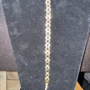 Gold tone chain link bracelet with clear rhinestones in some of the links